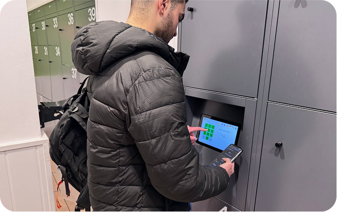 Photo of the storage facility at Atocha - Museo del Prado, Madrid with a person using the screen to open their locker