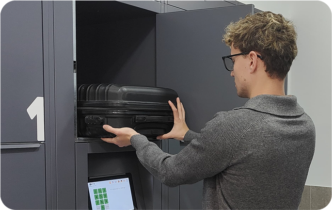 Photo of the storage facility at Santos, Lisbon with a user placing luggage in the locker